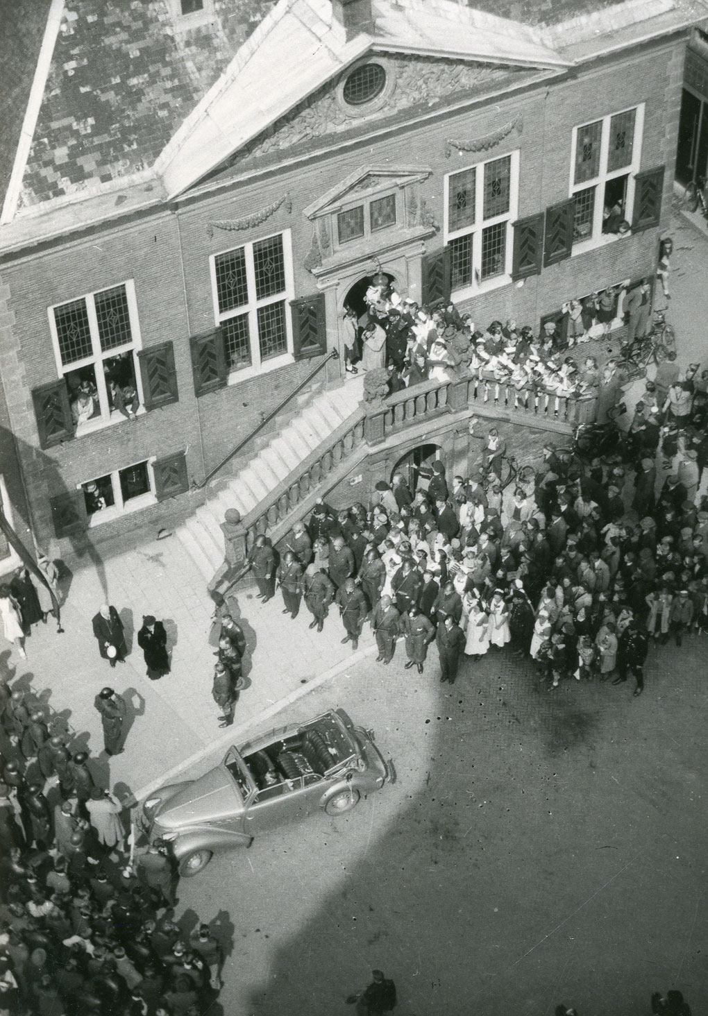 Aankomst van burgemeester M.C. Siezen bij het stadhuis op dinsdag 8 mei 1945. Even daarvoor is hij opgehaald bij het Hofsingel Ziekenhuis waar hij onder de schuilnaam ‘Piet Vermaas’ was verlost van een zogeheten ‘negenoog,’ een grote steenpuist.